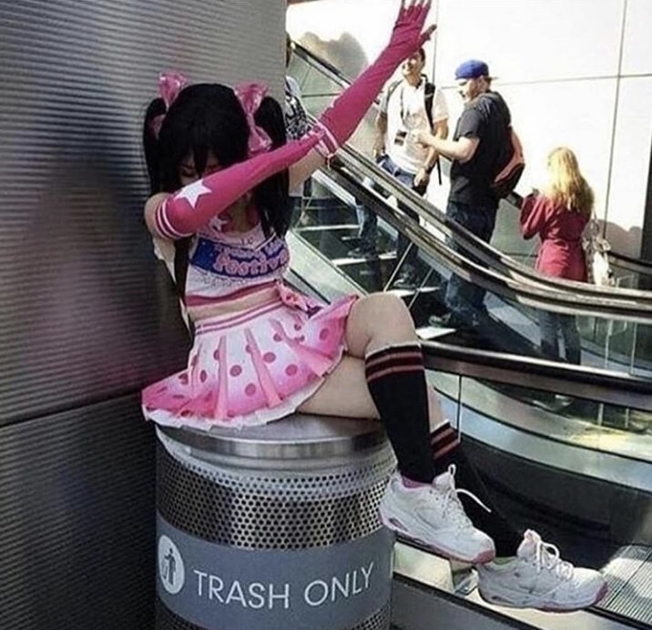 dabbing cosplayer in the trash