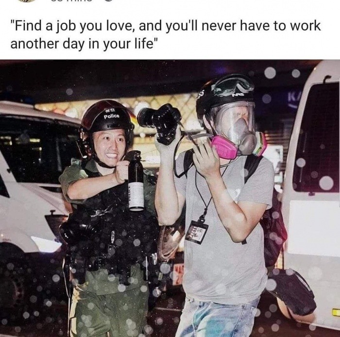 hong kong police pepper spray smiling - "Find a job you love, and you'll never have to work another day in your life" police