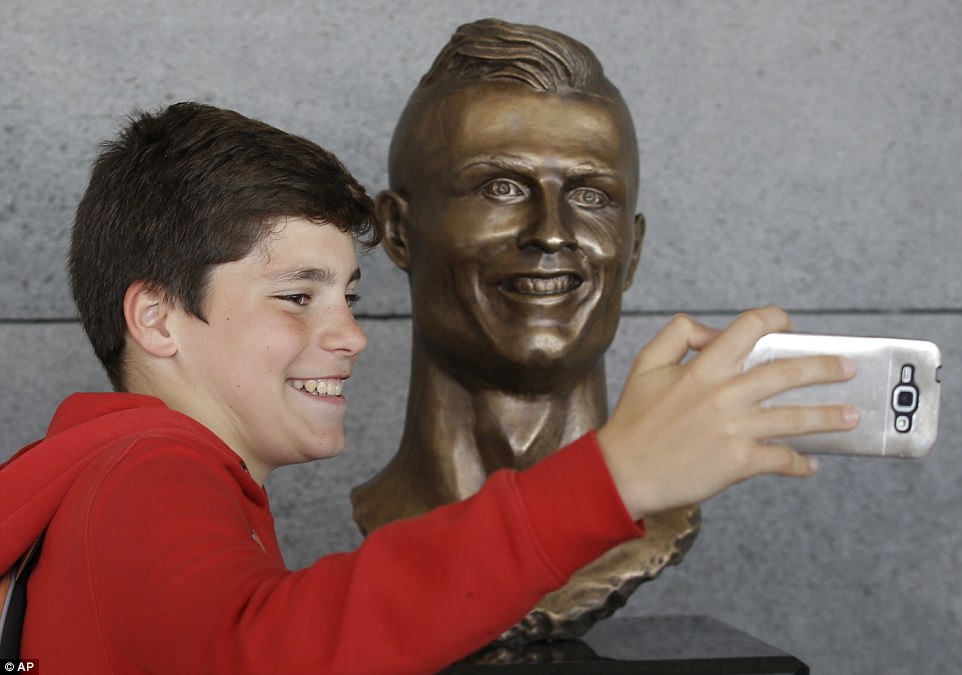 Young fans were desperate to get pictures of themselves alongside the statue of the Real Madrid football icon