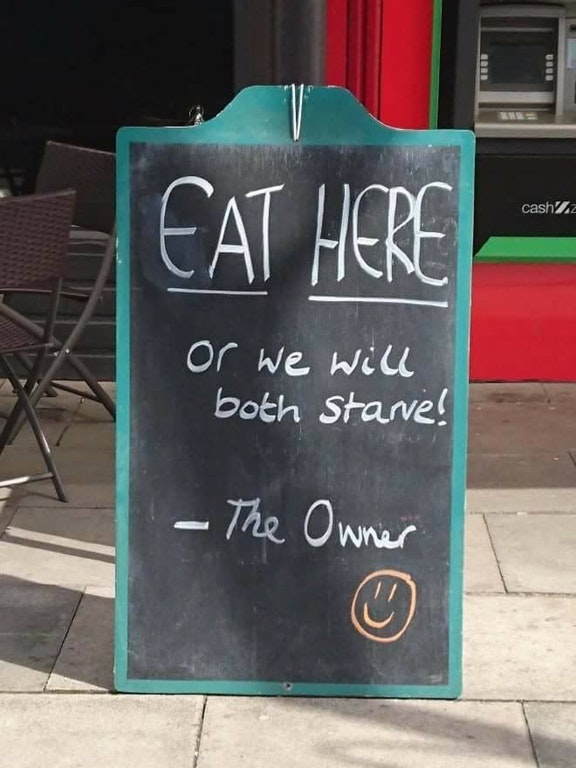 funny sign saying eat here or we both starve