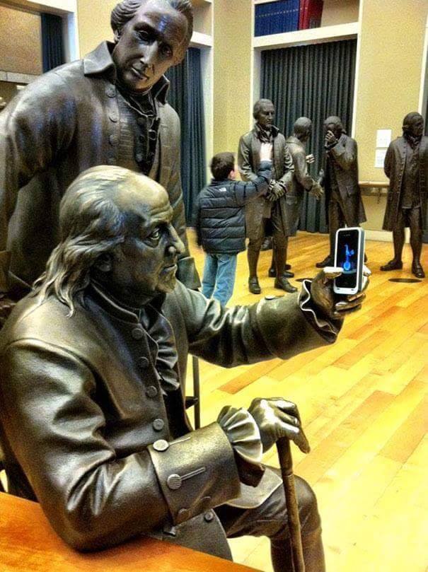 statues with a phone