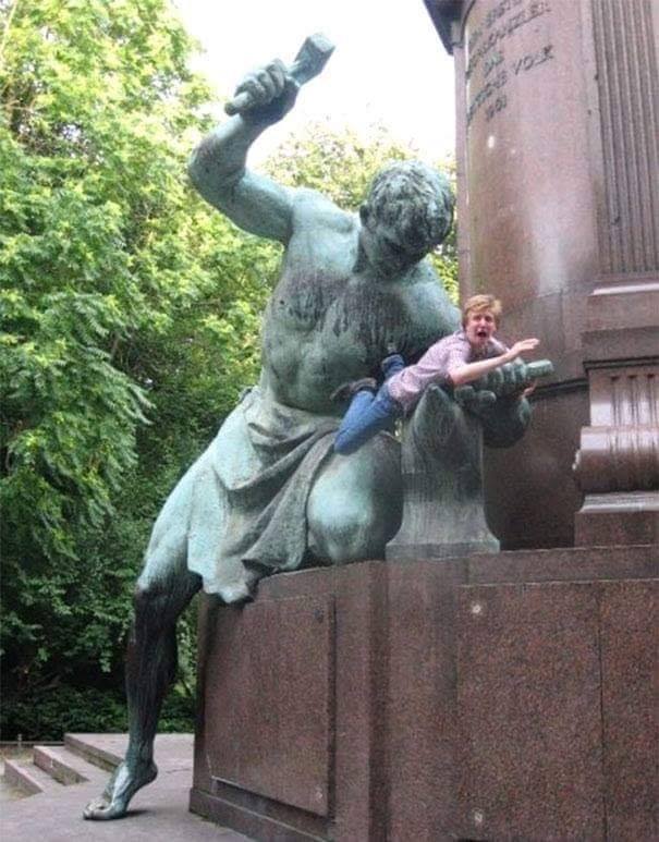 being beaten by a statue