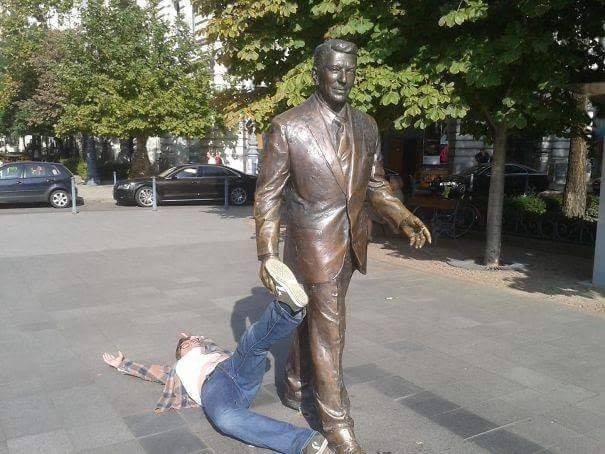 statue dragging man thru the streets