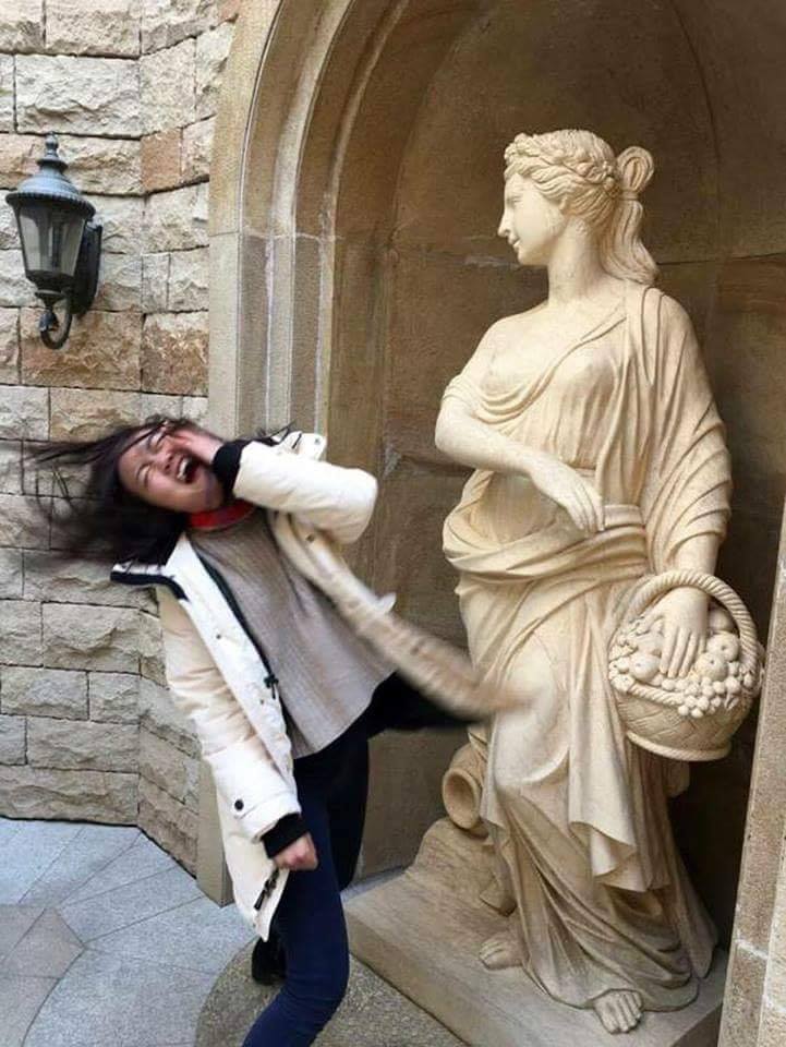 marble statue that looks like is slapped a woman