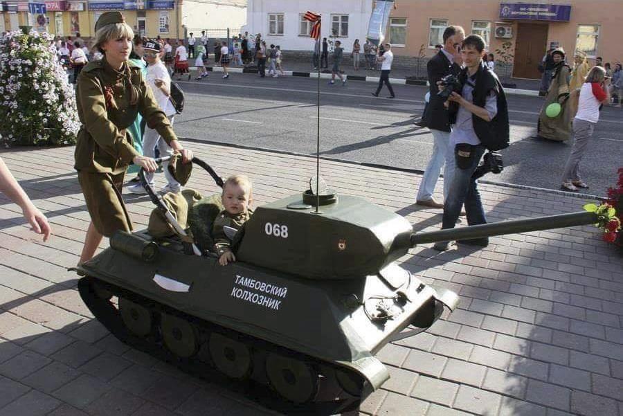 picture of a normal day in russia in which a baby carriage is modified to look like a tank