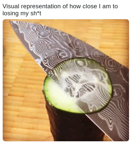 knife cutting a real thin slice of cucumber
