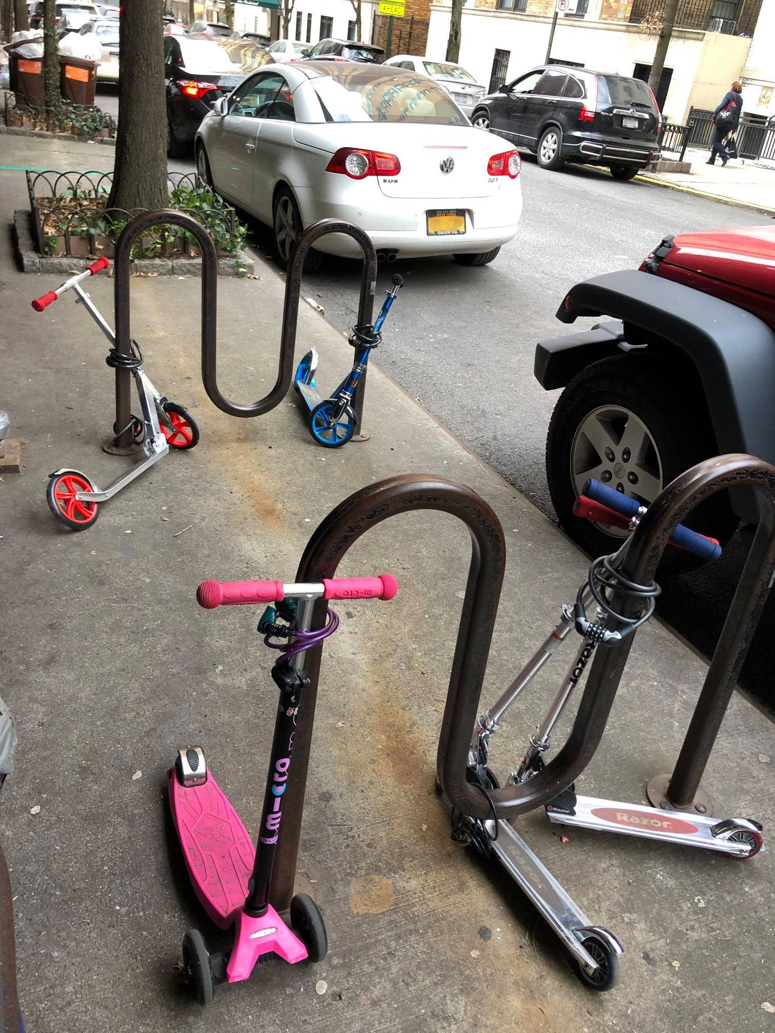 pic of electric scooters tied together to a bike rack