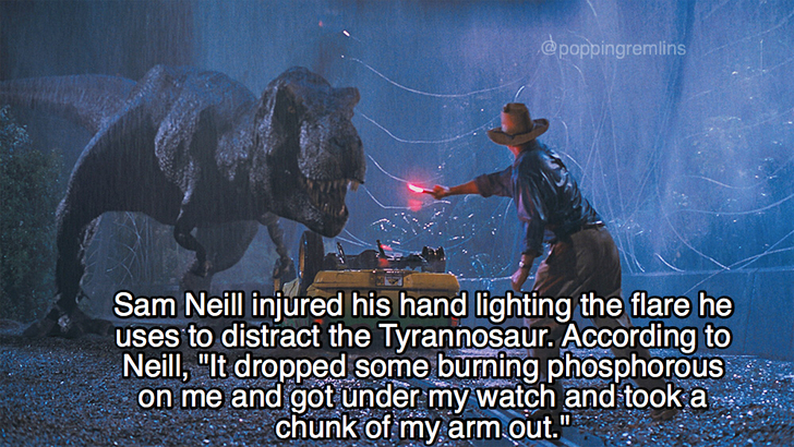 photo caption - Sam Neill injured his hand lighting the flare he uses to distract the Tyrannosaur. According to Neill, "It dropped some burning phosphorous on me and got under my watch and took a chunk of my arm out."