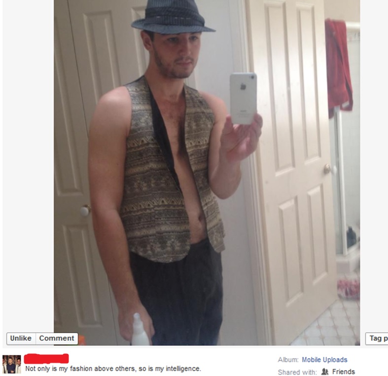 Selfie of dude wearing a vest and no shirt.