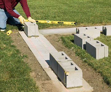 Building end leads: Step 2

At this point, you can continue to build up the lead on one corner, then the other, or build both of them at the same time. To start the other lead, push a corner block into mortar at the other end. You can attach mason's blocks and line from one corner to the other to help keep them straight.