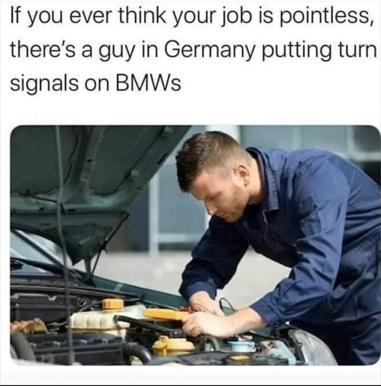mechanic repairing car on road trip - If you ever think your job is pointless, there's a guy in Germany putting turn signals on Bmws