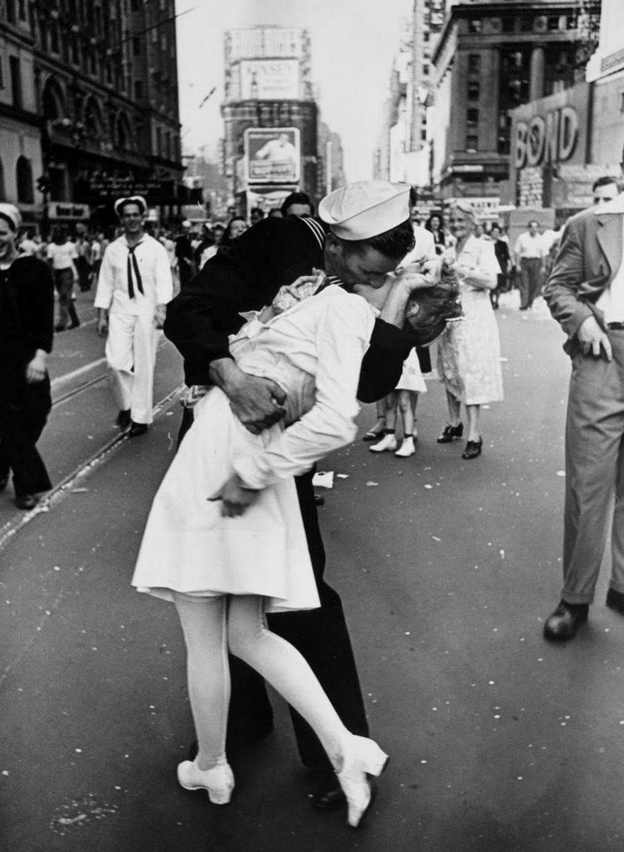 V-J Day In Times Square, Alfred Eisenstaedt, 1945

At its best, photography captures fleeting snippets that crystallize the hope, anguish, wonder and joy of life. Alfred Eisenstaedt, one of the first four photographers hired by LIFE magazine, made it his mission “to find and catch the storytelling moment.” He didn’t have to go far for it when World War II ended on August 14, 1945. Taking in the mood on the streets of New York City, Eisenstaedt soon found himself in the joyous tumult of Times Square. As he searched for subjects, a sailor in front of him grabbed hold of a nurse, tilted her back and kissed her. Eisenstaedt’s photograph of that passionate swoop distilled the relief and promise of that momentous day in a single moment of unbridled joy (although some argue today that it should be seen as a case of sexual assault). His beautiful image has become the most famous and frequently reproduced picture of the 20th century, and it forms the basis of our collective memory of that transformative moment in world history. “People tell me that when I’m in heaven,” Eisenstaedt said, “they will remember this picture.”