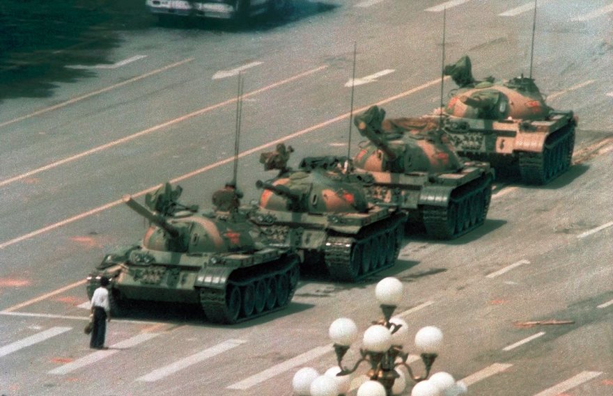 Tank Man, Jeff Widener, 1989

On the morning of June 5, 1989, photographer Jeff Widener was perched on a sixth-floor balcony of the Beijing Hotel. It was a day after the Tiananmen Square massacre, when Chinese troops attacked pro-democracy demonstrators camped on the plaza, and the Associated Press sent Widener to document the aftermath. As he photographed bloody victims, passersby on bicycles and the occasional scorched bus, a column of tanks began rolling out of the ­plaza. Widener lined up his lens just as a man carrying shopping bags stepped in front of the war machines, waving his arms and refusing to move. The tanks tried to go around the man, but he stepped back into their path, climbing atop one briefly. Widener assumed the man would be killed, but the tanks held their fire. Eventually the man was whisked away, but not before Widener immortalized his singular act of resistance. Others also captured the scene, but Widener’s image was transmitted over the AP wire and appeared on front pages all over the world. Decades after Tank Man became a global hero, he remains unidentified. The anonymity makes the photograph all the more universal, a symbol of resistance to unjust regimes everywhere.
