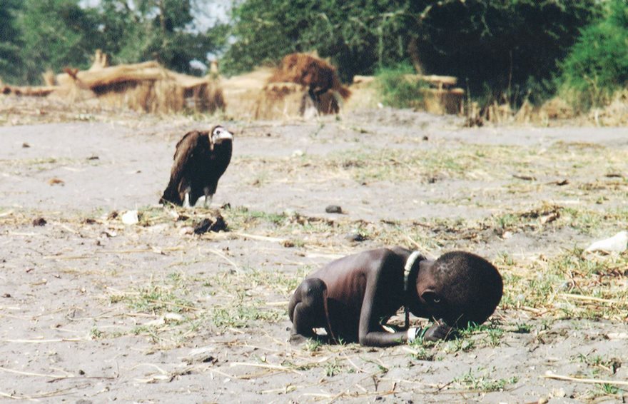 Starving Child And Vulture, Kevin Carter, 1993

Kevin Carter knew the stench of death. As a member of the Bang-Bang Club, a quartet of brave photographers who chronicled apartheid-­era South Africa, he had seen more than his share of heartbreak. In 1993 he flew to Sudan to photograph the famine racking that land. Exhausted after a day of taking pictures in the village of Ayod, he headed out into the open bush. There he heard whimpering and came across an emaciated toddler who had collapsed on the way to a feeding center. As he took the child’s picture, a plump vulture landed nearby. Carter had reportedly been advised not to touch the victims because of disease, so instead of helping, he spent 20 minutes waiting in the hope that the stalking bird would open its wings. It did not. Carter scared the creature away and watched as the child continued toward the center. He then lit a cigarette, talked to God and wept. The New York Times ran the photo, and readers were eager to find out what happened to the child—and to criticize Carter for not coming to his subject’s aid. His image quickly became a wrenching case study in the debate over when photographers should intervene. Subsequent research seemed to reveal that the child did survive yet died 14 years later from malarial fever. Carter won a Pulitzer for his image, but the darkness of that bright day never lifted from him. In July 1994 he took his own life, writing, “I am haunted by the vivid memories of killings & corpses & anger & pain.”