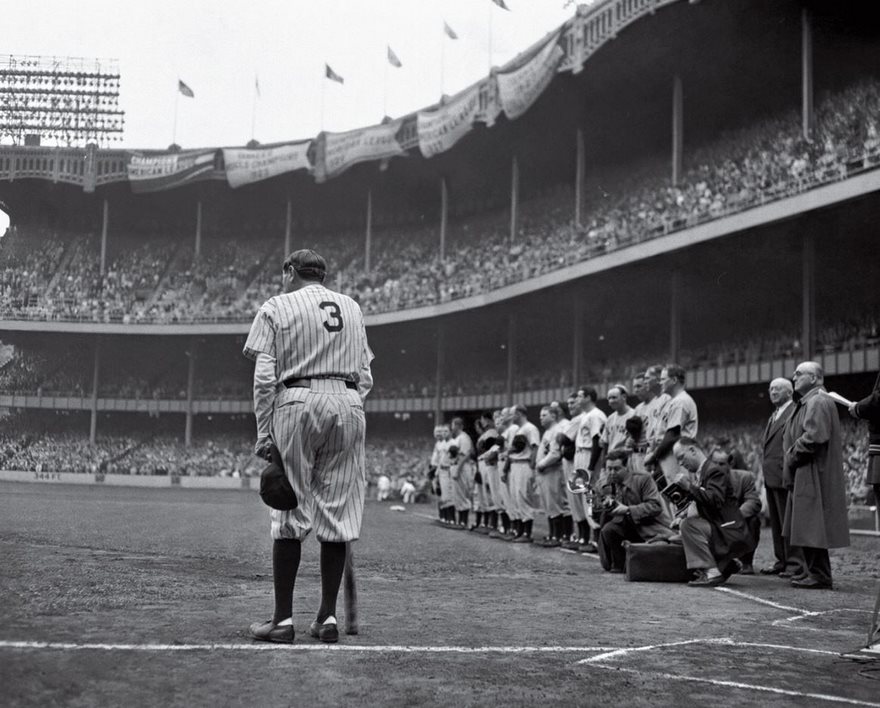 The Babe Bows Out, Nat Fein, 1948. He was the greatest ballplayer of them all, the towering Sultan of Swat. But by 1948, Babe Ruth had been out of the game for more than a decade and was struggling with terminal cancer. So when the beloved Bambino stood before a massive crowd on June 13 to help celebrate the silver anniversary of Yankee Stadium—known to all in attendance as the House That Ruth Built—and to retire his No. 3, it was clear this was a final public goodbye. Nat Fein of the New York Herald Tribune was one of dozens of photographers staked out along the first-base line. But as the sound of “Auld Lang Syne” filled the stadium, Fein “got a feeling” and walked behind Ruth, where he saw the proud ballplayer leaning on a bat, his thin legs hinting at the toll the disease had wreaked on his body. From that spot, Fein captured the almost mythic role that athletes play in our lives—even at their weakest, they loom large. Two months later Ruth was dead, and Fein went on to win a Pulitzer Prize for his picture. It was the first one awarded to a sports photographer, giving critical legitimacy to a form other than hard-news reportage.