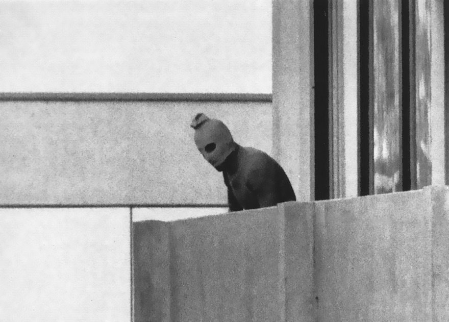 Munich Massacre, Kurt Strumpf, 1972. The Olympics celebrate the best of humanity, and in 1972 Germany welcomed the Games to exalt its athletes, tout its democracy and purge the stench of Adolf Hitler’s 1936 Games. The Germans called it “the Games of peace and joy,” and as Israeli fencer Dan Alon recalled, “Taking part in the opening ceremony, only 36 years after Berlin, was one of the most beautiful moments in my life.” Security was lax so as to project the feeling of harmony. Unfortunately, this made it easy on September 5 for eight members of the Palestinian terrorist group Black September to raid the Munich Olympic Village building housing ­Israeli Olympians. Armed with grenades and assault rifles, the terrorists killed two team members, took nine hostage and demanded the release of 234 of their jailed compatriots. The 21-hour hostage standoff presented the world with its first live window on terrorism, and 900 million people tuned in. During the siege, one of the Black Septemberists made his way out onto the apartment’s balcony. As he did, Associated Press photographer Kurt Strumpf froze this haunting image, the faceless look of terror. As the Palestinians attempted to flee, German snipers tried to take them out, and the Palestinians killed the hostages and a policeman. The already fraught Arab-Israeli relationship became even more so, and the siege led to retaliatory attacks on Palestinian bases. Strumpf’s photo of that specter with cut-out eyes is a sobering reminder of how we were all diminished when the world realized that nothing was secure.