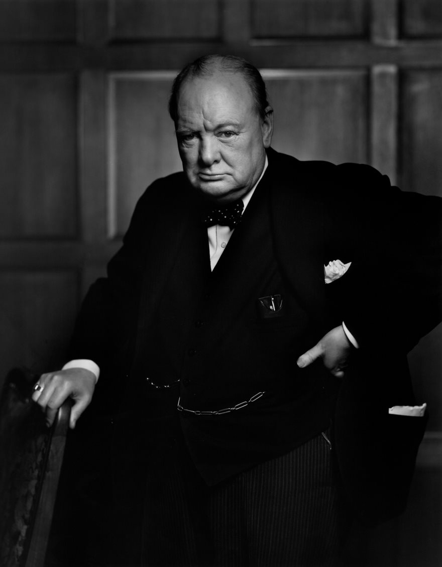 Winston Churchill, Yousuf Karsh, 1941.  Britain stood alone in 1941. By then Poland, France and large parts of Europe had fallen to the Nazi forces, and it was only the tiny nation’s pilots, soldiers and sailors, along with those of the Commonwealth, who kept the darkness at bay. Winston Churchill was determined that the light of England would continue to shine. In December 1941, soon after the Japanese attacked Pearl Harbor and America was pulled into the war, Churchill visited Parliament in Ottawa to thank Canada and the Allies for their help. Churchill wasn’t aware that Yousuf Karsh had been tasked to take his portrait afterward, and when he came out and saw the Turkish-born Canadian photographer, he demanded to know, “Why was I not told?” Churchill then lit a cigar, puffed at it and said to the photographer, “You may take one.” As Karsh prepared, Churchill refused to put down the cigar. So once Karsh made sure all was ready, he walked over to the Prime Minister and said, “Forgive me, sir,” and plucked the cigar out of Churchill’s mouth. “By the time I got back to my camera, he looked so belligerent, he could have devoured me. It was at that instant that I took the photograph.” Ever the diplomat, Churchill then smiled and said, “You may take another one” and shook Karsh’s hand, telling him, “You can even make a roaring lion stand still to be photographed.” The result of Karsh’s lion taming is one of the most widely reproduced images in history and a watershed in the art of political portraiture. It was Karsh’s picture of the bulldoggish Churchill—published first in the American daily PM and eventually on the cover of LIFE—that gave modern photographers permission to make honest, even critical portrayals of our leaders.