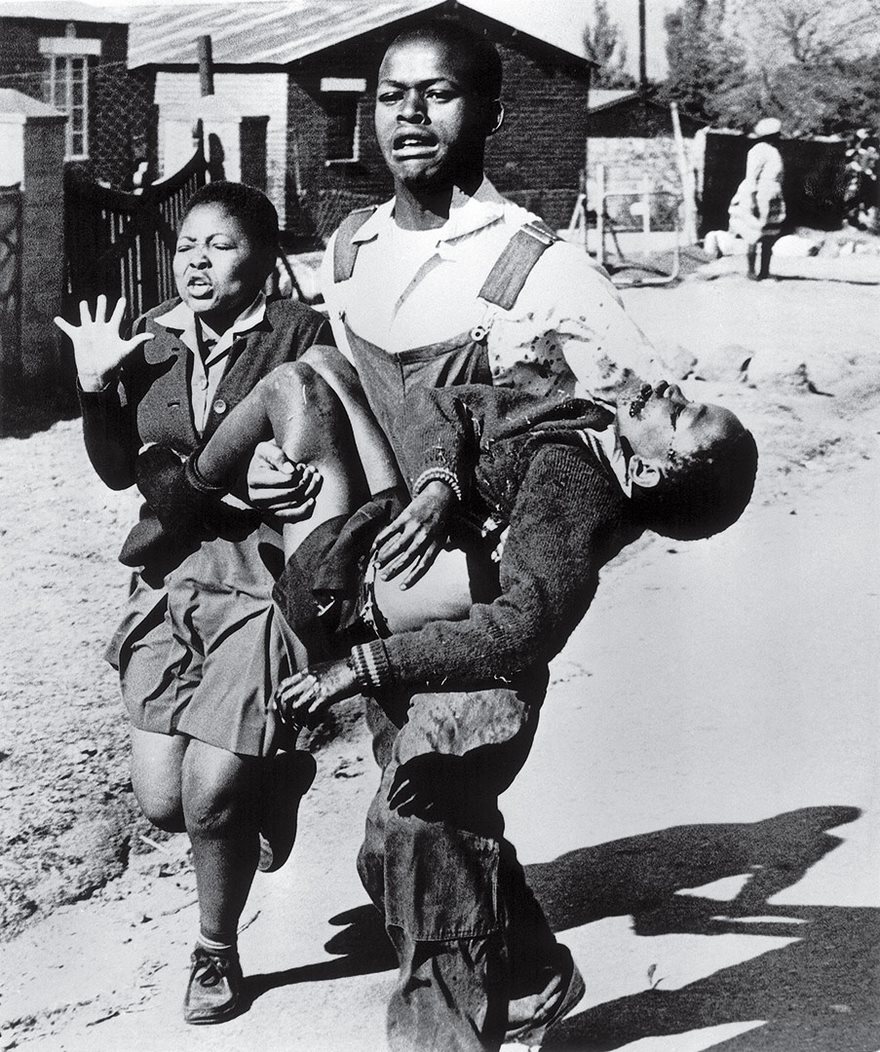 Soweto Uprising, Sam Nzima, 1976. Few outside South Africa paid much attention to apartheid before June 16, 1976, when several thousand Soweto students set out to protest the introduction of mandatory Afrikaans-language instruction in their township schools. Along the way they gathered youngsters from other schools, including a 13-year-old student named Hector Pieterson. Skirmishes started to break out with the police, and at one point officers fired tear gas. When students hurled stones, the police shot real bullets into the crowd. “At first, I ran away from the scene,” recalled Sam Nzima, who was covering the protests for the World, the paper that was the house organ of black Johannesburg. “But then, after recovering myself, I went back.” That is when Nzima says he spotted Pieterson fall down as gunfire showered above. He kept taking pictures as terrified high schooler Mbuyisa Makhubu picked up the lifeless boy and ran with Pieterson’s sister, Antoinette Sithole. What began as a peaceful protest soon turned into a violent uprising, claiming hundreds of lives across South Africa. Prime Minister John Vorster warned, “This government will not be intimidated.” But the armed rulers were powerless against Nzima’s photo of Pieterson, which showed how the South African regime killed its own people. The picture’s publication forced Nzima into hiding amid death threats, but its effect could not have been more visible. Suddenly the world could no longer ignore apartheid. The seeds of international opposition that would eventually topple the racist system had been planted by a photograph.
