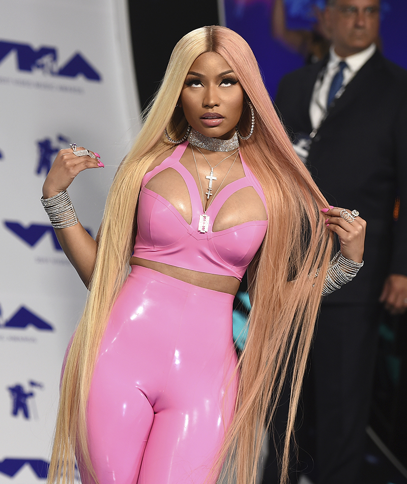 Pop music star Nicki Minaj posing for the camera wearing a bright pink outfit.