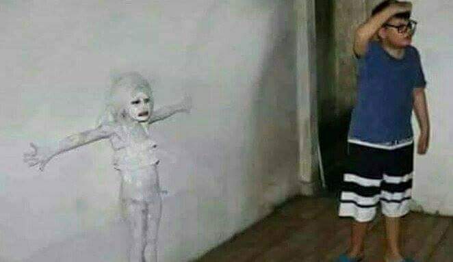 A cursed image of a girl painted into a wall with a boy looking on. 
