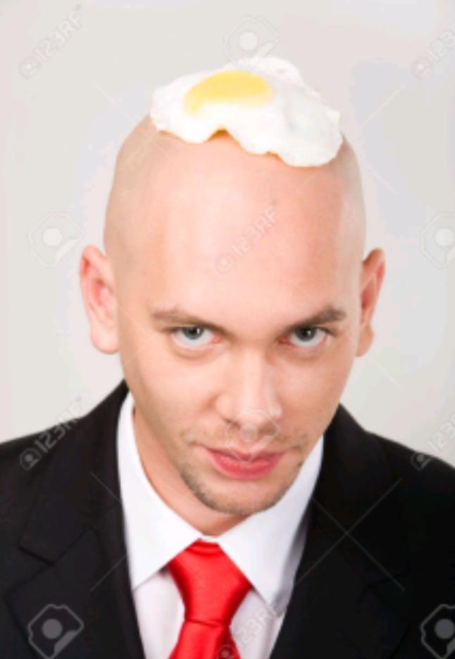 A very strange stock photo with a bald businessman with a fried egg on his head. 