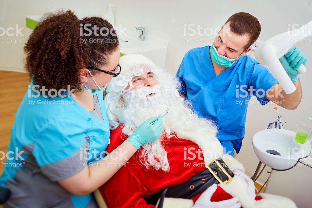 A super weird stock photo of Santa Claus at a dentist office about to get work done. 