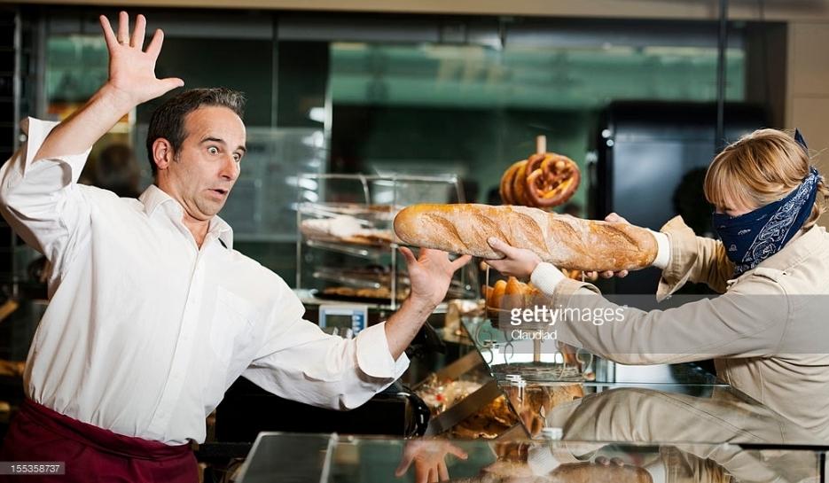 A super strange and hilarious stock photo from getty of a lady holding up a bakery with french bread. 
