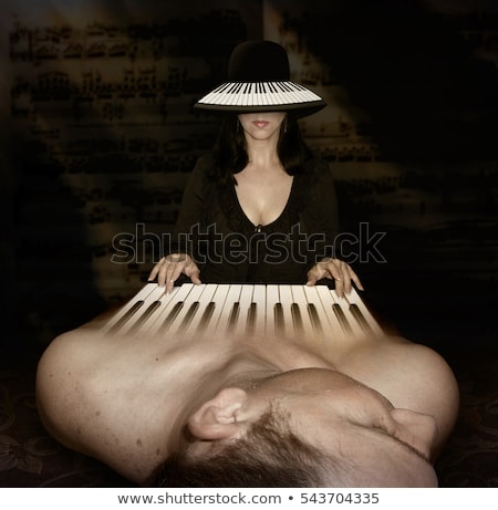 A super weird stock photo of a woman with a keyboard head playing a man with a keyboard body. 