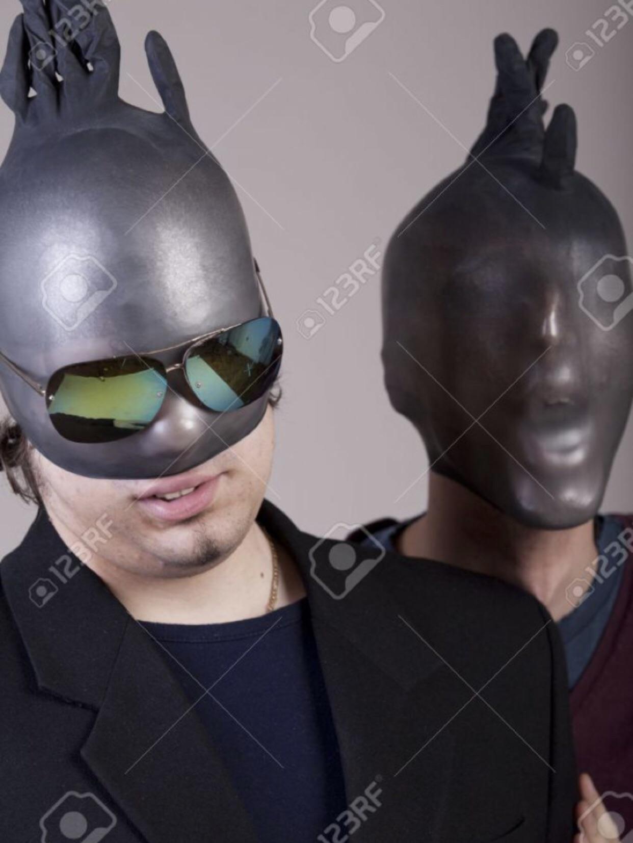 A crazy WTF stock photo of two guys with black rubber gloves on their heads with one of them wearing sunglasses as well. 