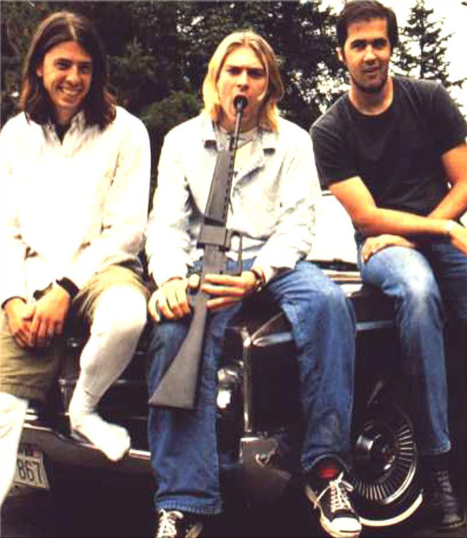A photo of Nirvana where Kurt Cobain has a gun in his mouth