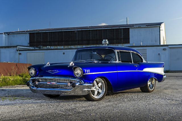 The 1956 Bel Air received a face-lift with a more conventional full-width grille, pleasing those customers who didn't favor the Ferrari-inspired '55 front end. Distinctive two-tone bodyside treatments and graceful front and rear wheel openings completed the "speedline" restyling. Single housings incorporated the taillight, stoplight, and backup light, and the left one held the gas filler - an idea popularized on Cadillacs. Among the seven Bel Air models was a new Sport Sedan, a pillarless four-door hardtop that looked handsome with all the windows rolled down and allowed easy entry into the back seat.