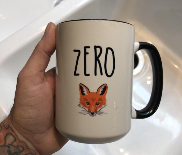 coffee mug with ZERO and a fox on it