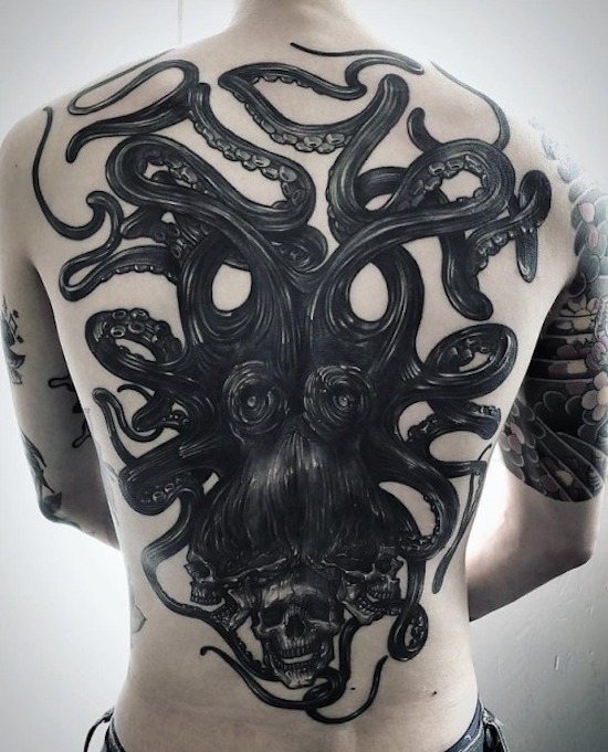 head of medusa tattoo on a person's back