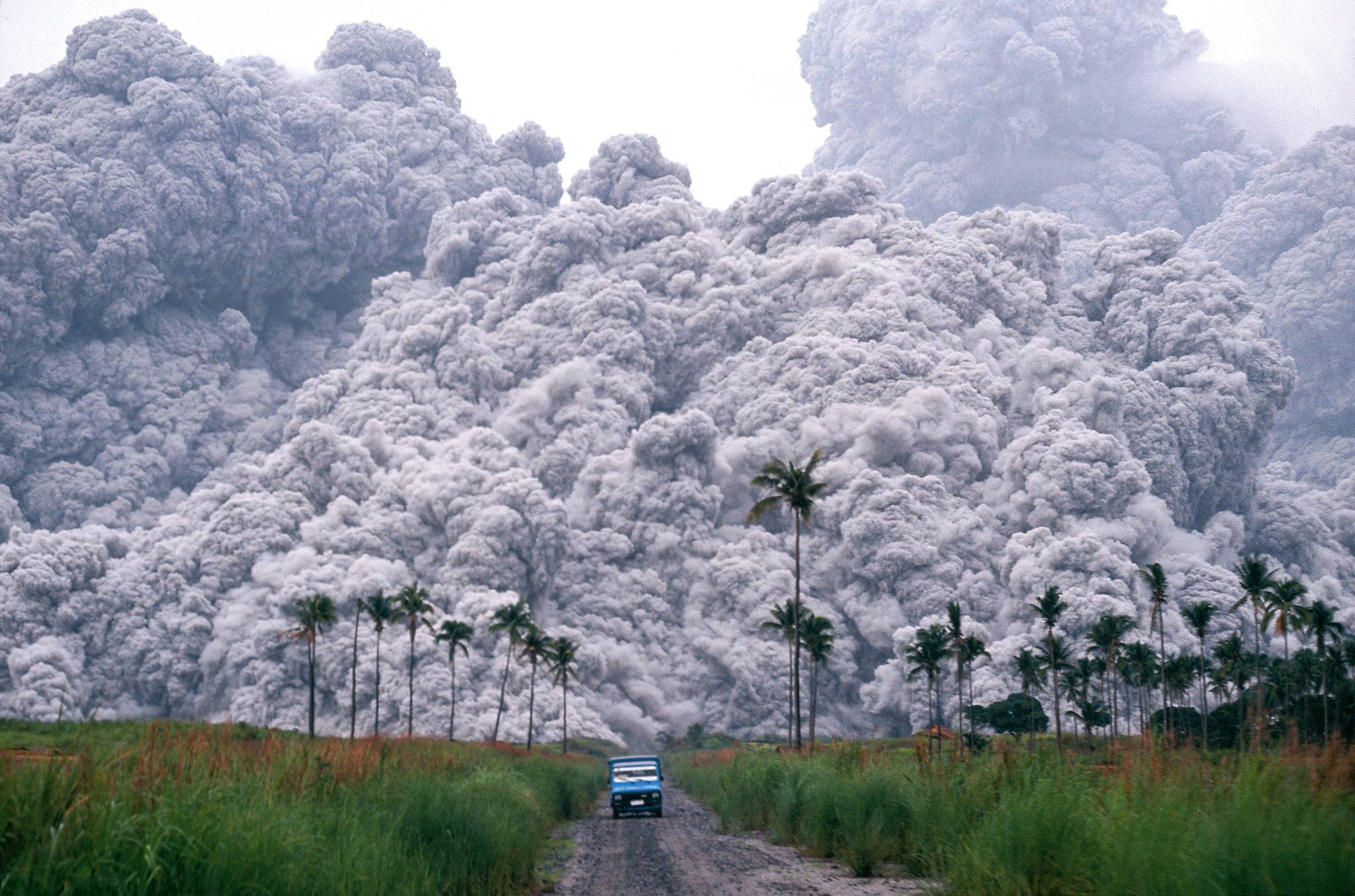 A pickup truck flees from the smoke and volcanic ash ( pyroclastic flows) spewing from the Mt. Pinatubo volcano that erupted during 1991 in the Philippines.  Amazingly the photographer Alberto Garcia survived this gut-wrenching scene and has won many awards for this amazing photograph. 