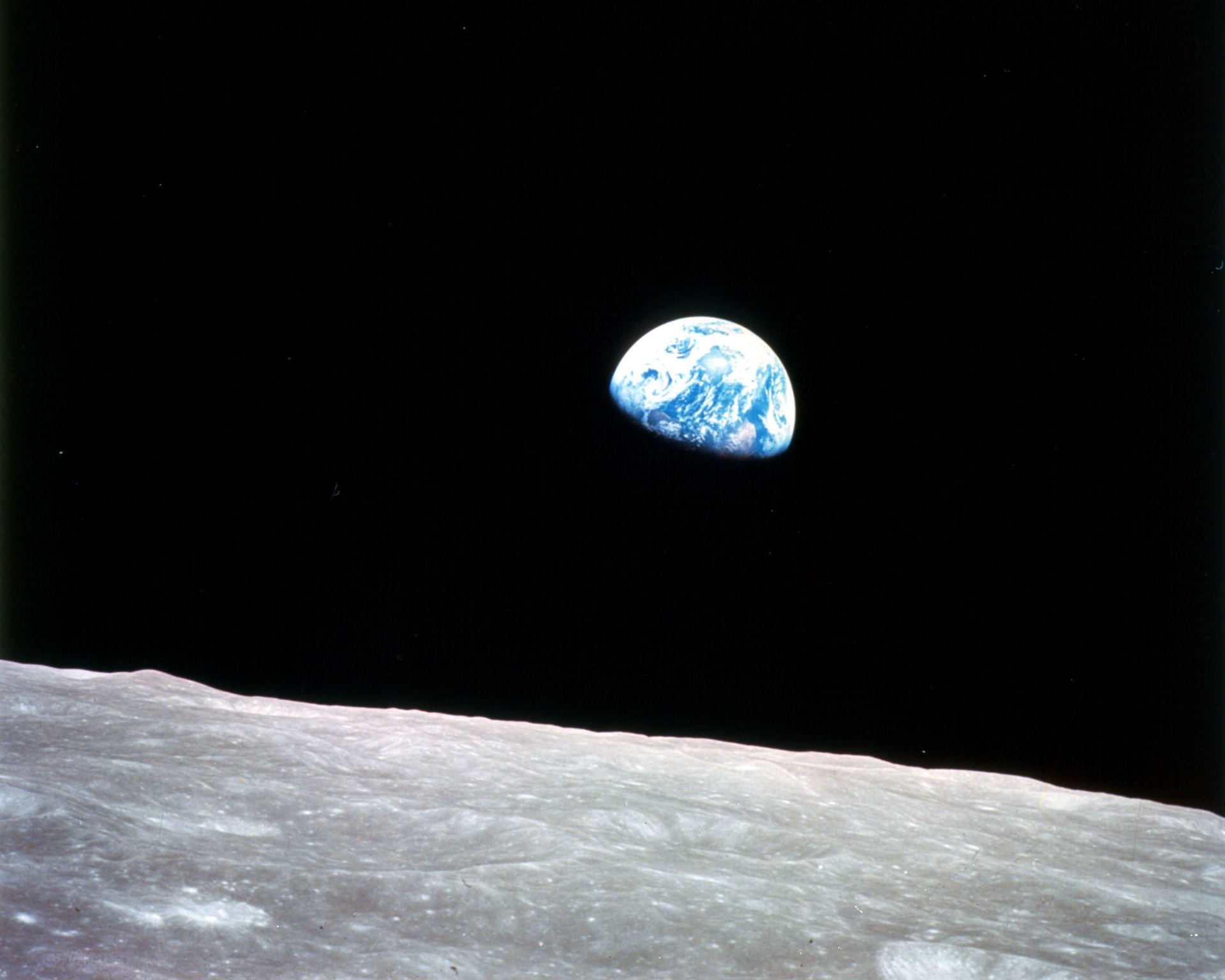This photograph, titled "Earthrise" was captured by Apollo 8 lunar module pilot Bill Anders during the first human voyage around the moon on Dec. 24, 1968. Anders flew around the moon with Apollo 8 commander Frank Borman and command module pilot Jim Lovell as they witnessed the Earth rising above the lunar surface.