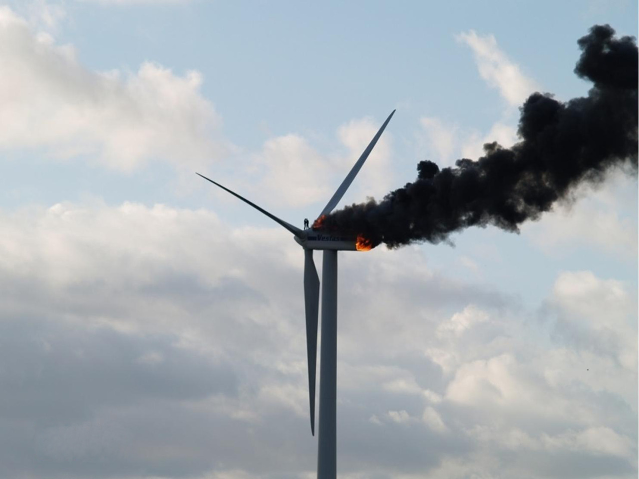 A heart breaking photograph of two engineers stranded atop a wind turbine that caught on fire. 
The two engineers are seen hugging each other as they accept the harsh reality that they are going to die.