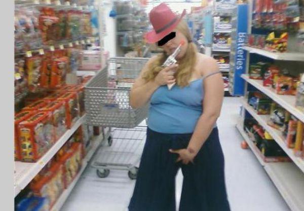 Woman grabbing her junk dressed as a cowboy