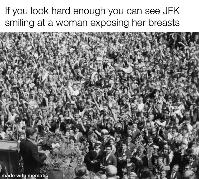black and white photo of JFK delivering speech to a large crowd - If you look hard enough you can see Jfk smiling at a woman exposing her breasts - rick astley is hidden in the crowd