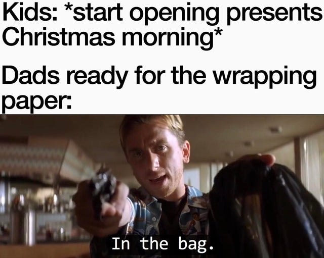 Gift wrapping - Kids start opening presents Christmas morning Dads ready for the wrapping paper In the bag.