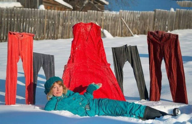 woman posing with frozen laundry