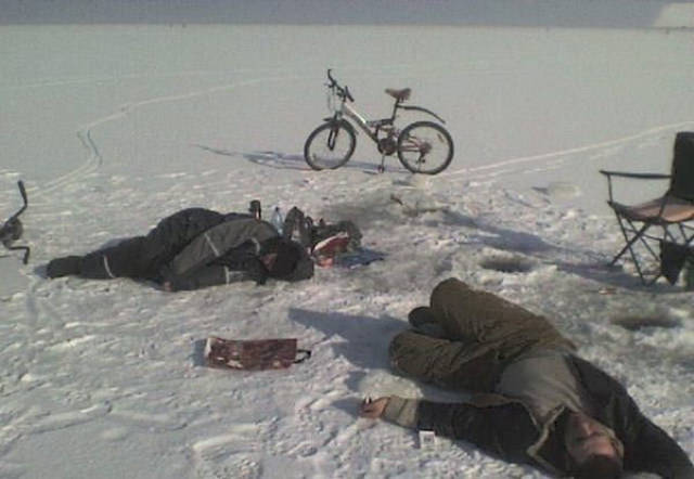 people passed out by local ice fishing hole on a frozen lake