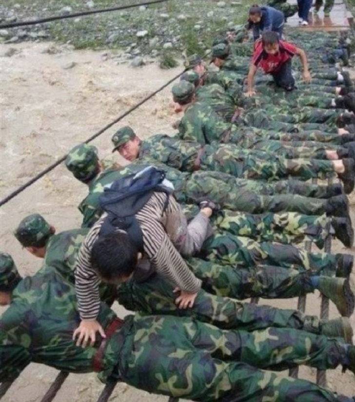 Soldiers have created a bridge with their bodies to save ppl who were affected by  floods.