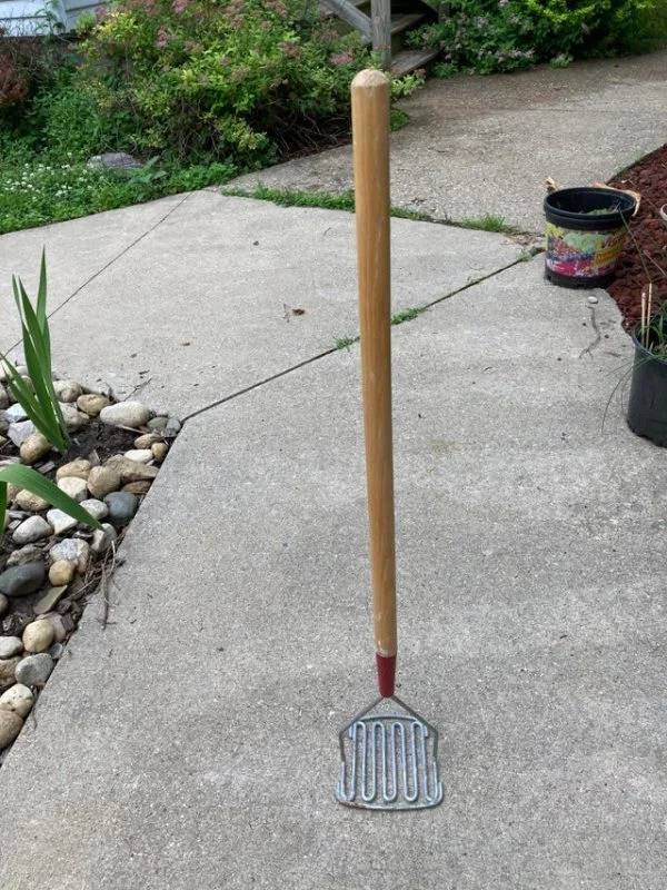Found in the basement of an old church in a cleaning closet. About 2.5 ft tall.It is a tool to mix drywall mud. Similar to a potato masher but for the drywall compound.