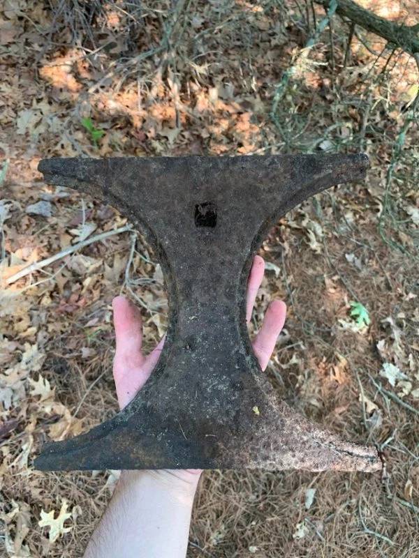 This iron piece was sticking out of the ground in the woods near a reservoir, it has a square indent on one side. Maybe related to farming or logging?Top of a cast iron stove