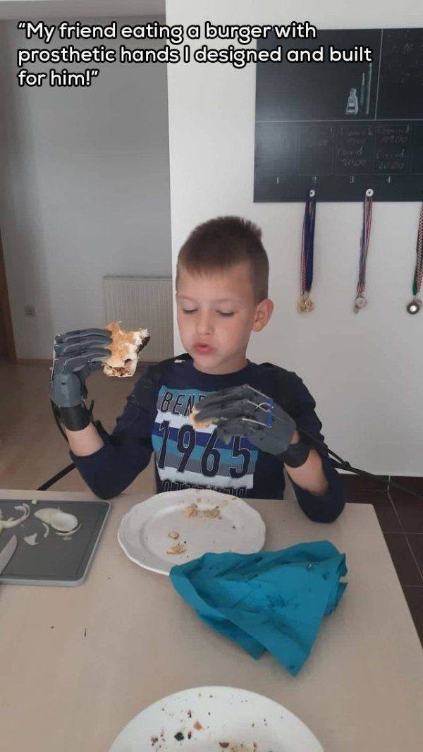 funny random pics - toddler - "My friend eating a burger with prosthetic hands I designed and built for him!" Ben 1965