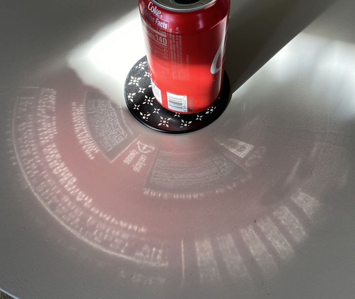 The reflection of the Coke can on the table looks like something out of “Stark Industries