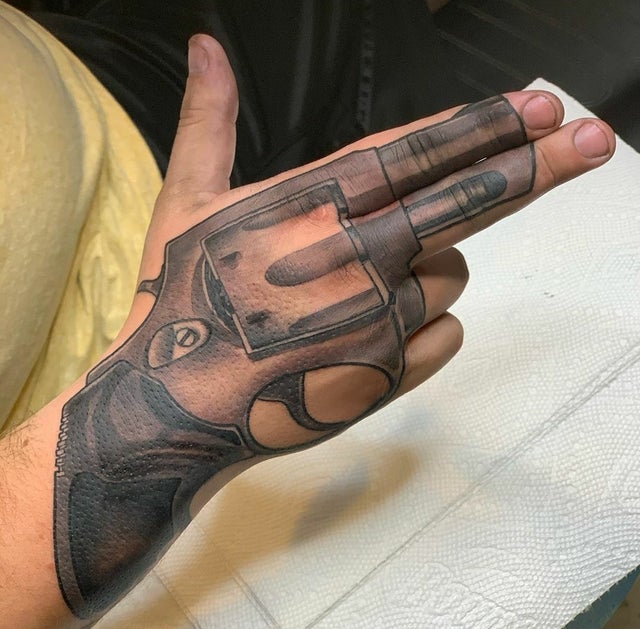 gun finger tattoo