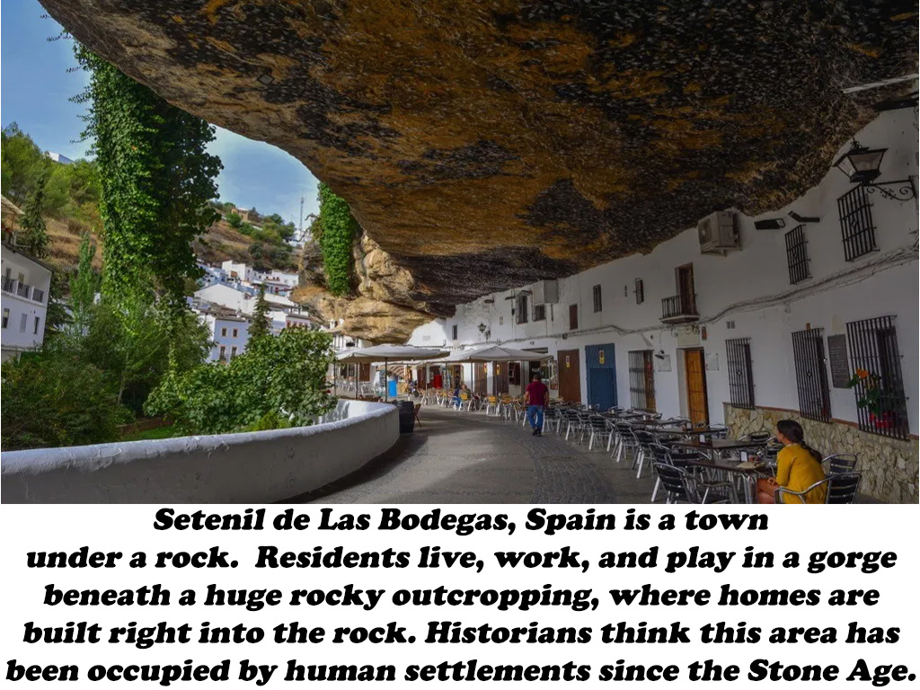Setenil de Las Bodegas, Spain is a town under a rock. Residents live, work, and play in a gorge beneath a huge rocky outcropping, where homes are built right into the rock. Historians think this area has been occupied by human settlements since the Stone…