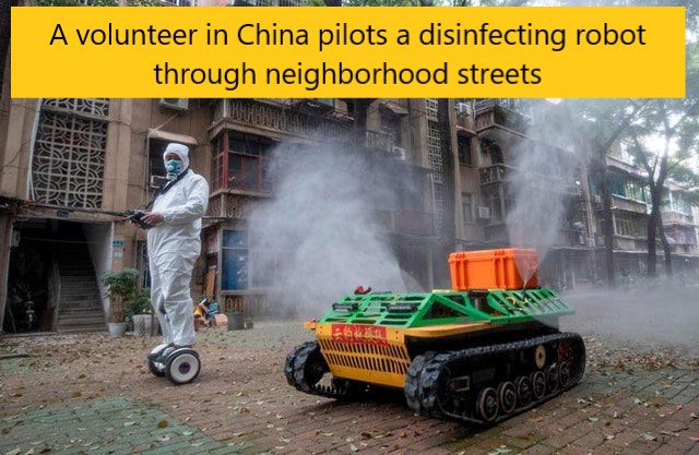 Coronavirus - & A volunteer in China pilots a disinfecting robot through neighborhood streets Mw