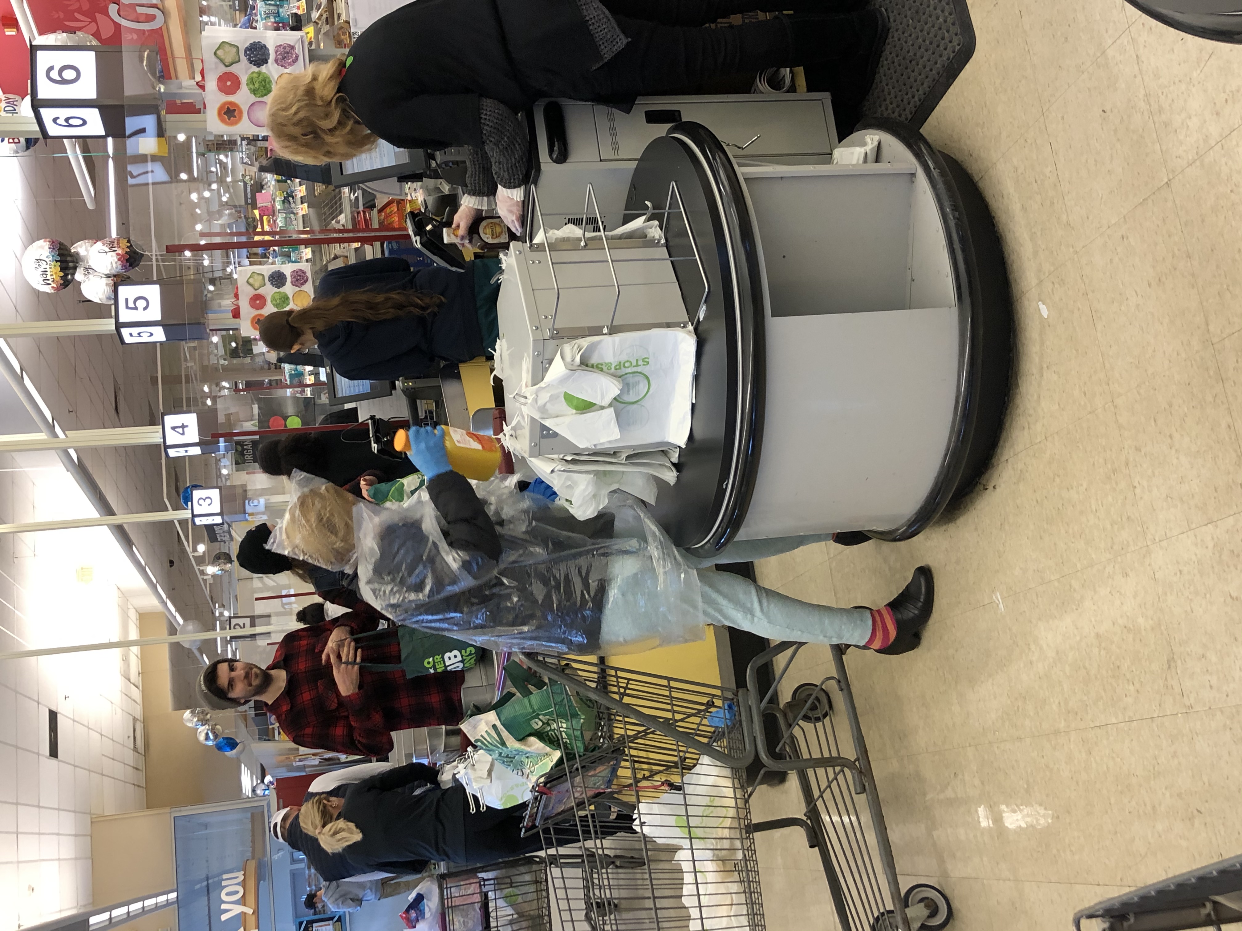 woman shopping at stop and shop wearing a plastic bag over her head